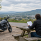 Who pays motorcycle medical bills during a Springdale claim, shown with a rider beside a parked motorcycle